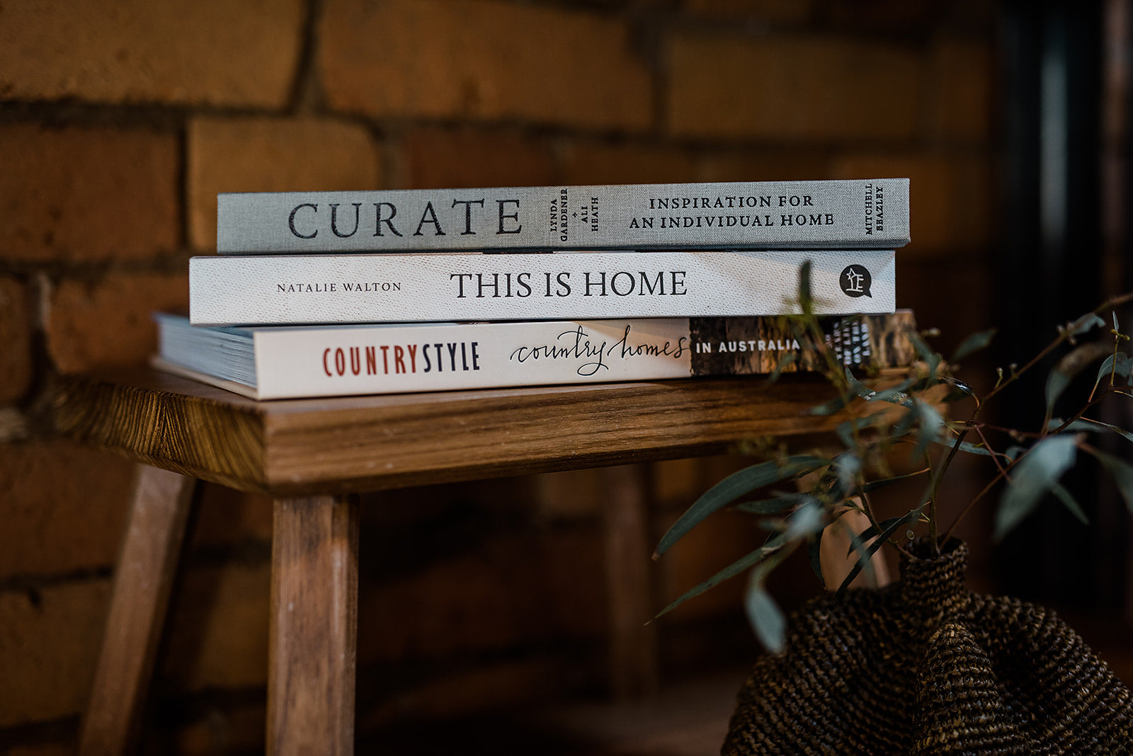 Stack of books on a wooden stool with a rustic background