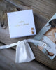 Jewelry set with 'atelier pollen & plume' box on a wooden surface